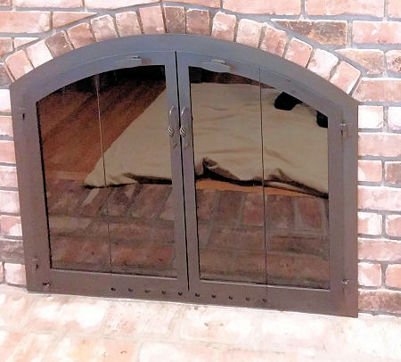 Nantucket Arch Black finish, vice bi fold doors, with birdcage center handles, standard smoked tempered glass, standard brick installation